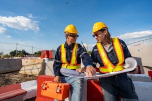 technicians inspecting construction plans