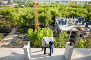 construction workers overlooking a nature area