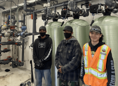 Industra Kwadacha Local workers next to water treatment plant system