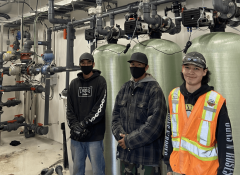 Industra - Kwadacha - Local workers next to water treatment plant system